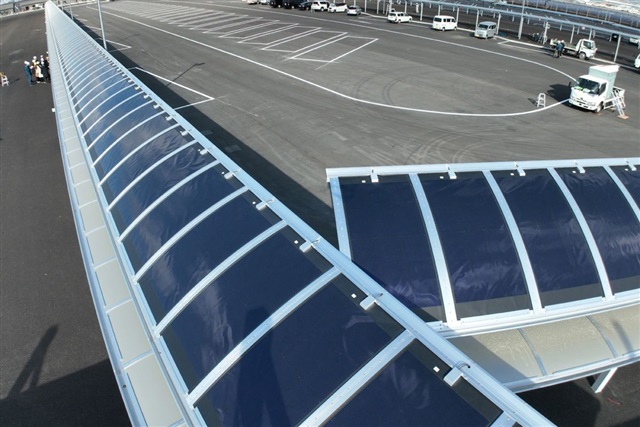 Illustration of flexible perovskite solar cells being printed onto a roll of material.