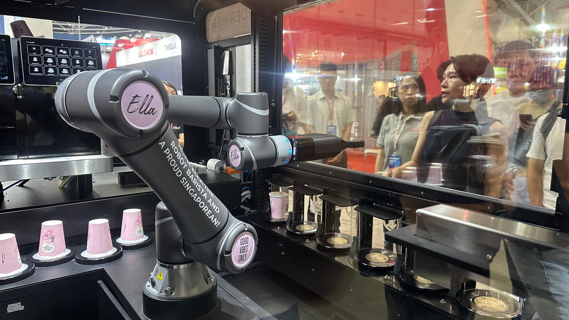 A sleek robot barista arm pouring a drink, with an Intel Core Ultra 3 chip highlighted.