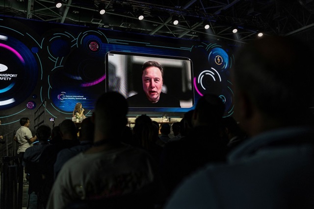Elon Musk looking thoughtful in front of a SpaceX rocket, with a subtle AI-themed graphic overlay.