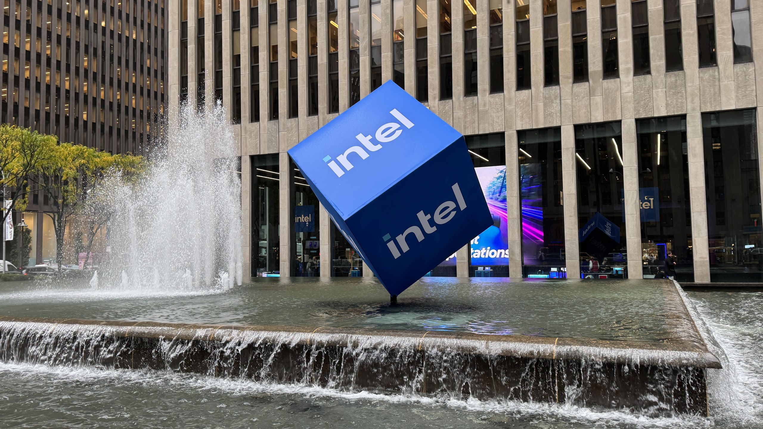 Intel stock chart surging past $300 billion market cap milestone with chip fab background