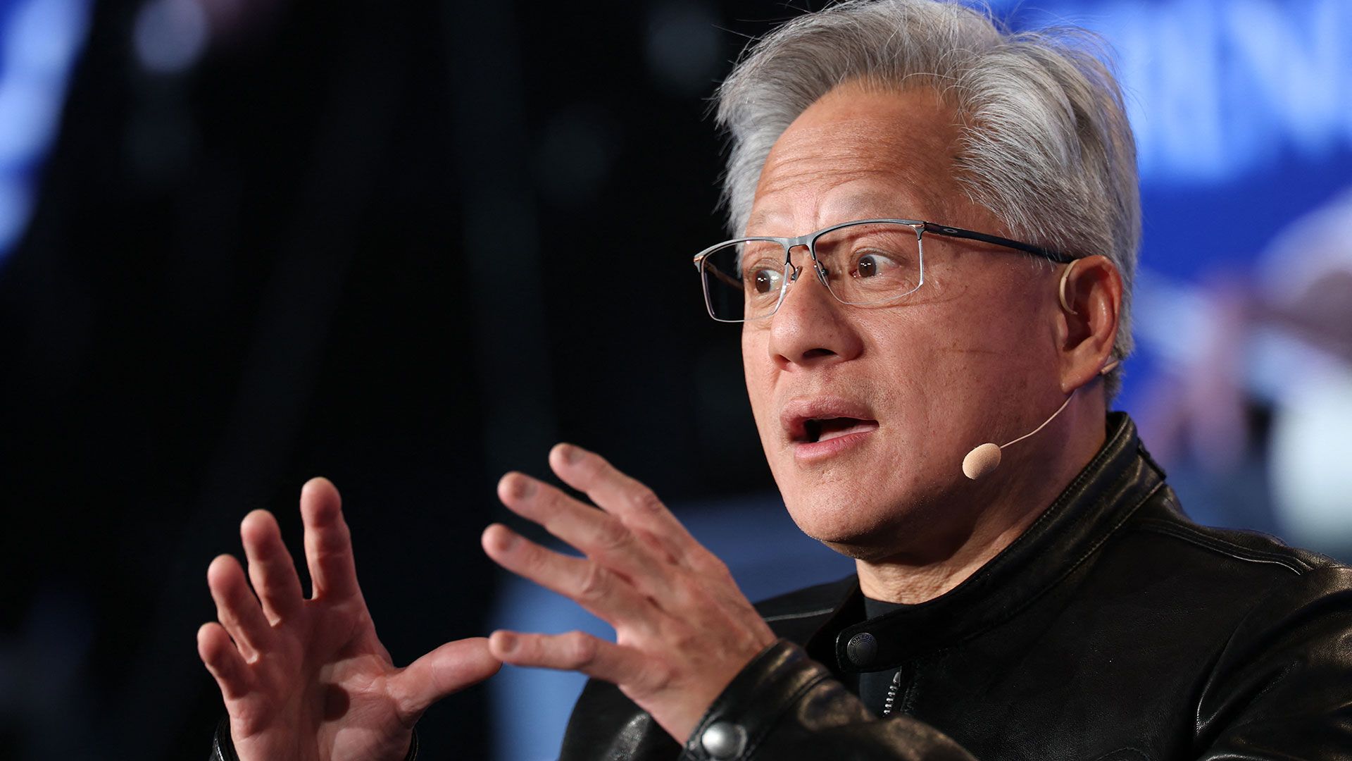Nvidia CEO Jensen Huang speaking to reporters at an airport