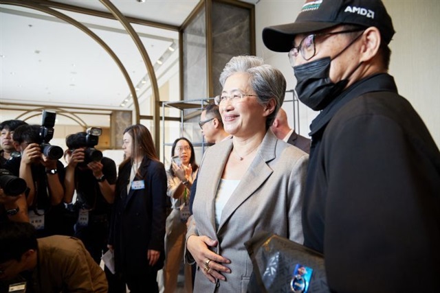 AMD CEO Lisa Su speaking at a conference, looking thoughtful.