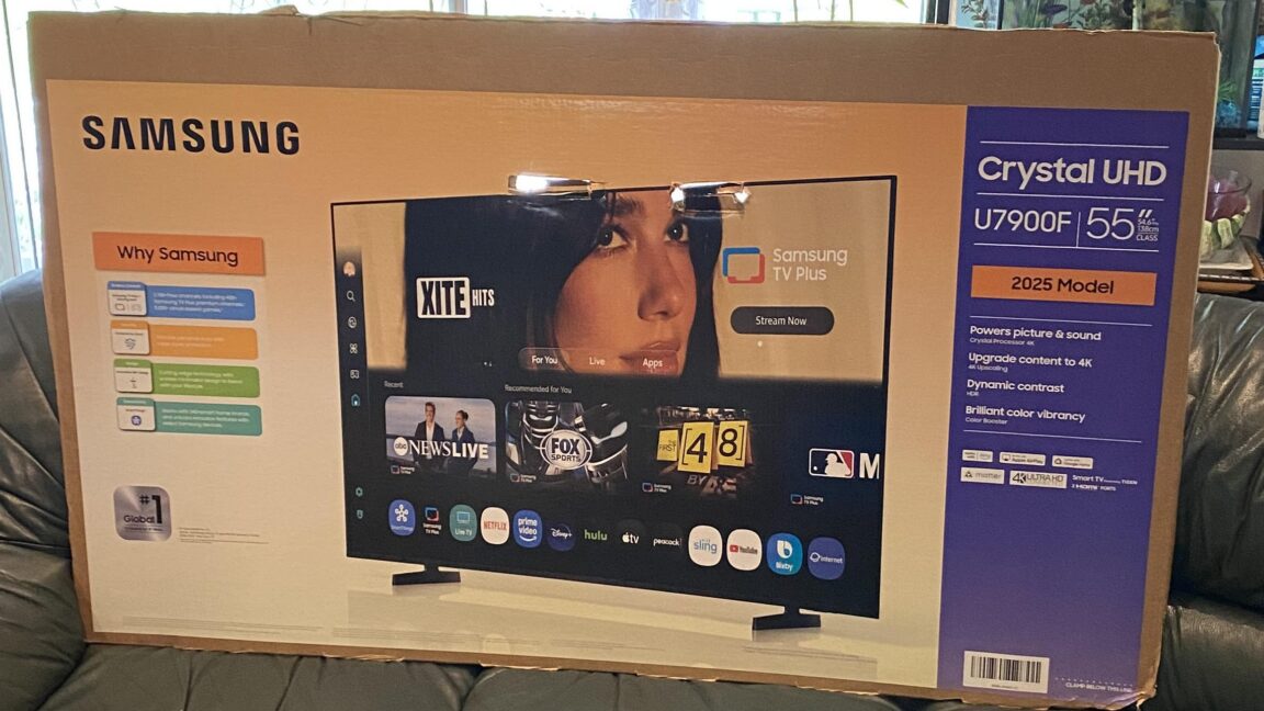A Samsung television box with an image of a woman, presumably Dua Lipa, visible on the packaging.