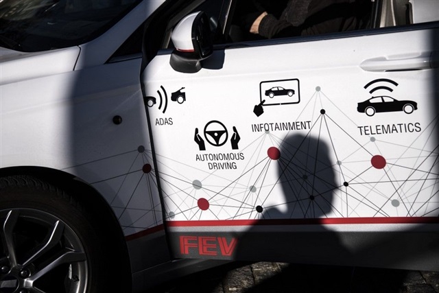 A visual metaphor depicting interconnected electronic components and car parts, with a prominent Chinese flag overlaying one side and a Taiwanese flag on the other, suggesting a dynamic and potentially strained relationship.