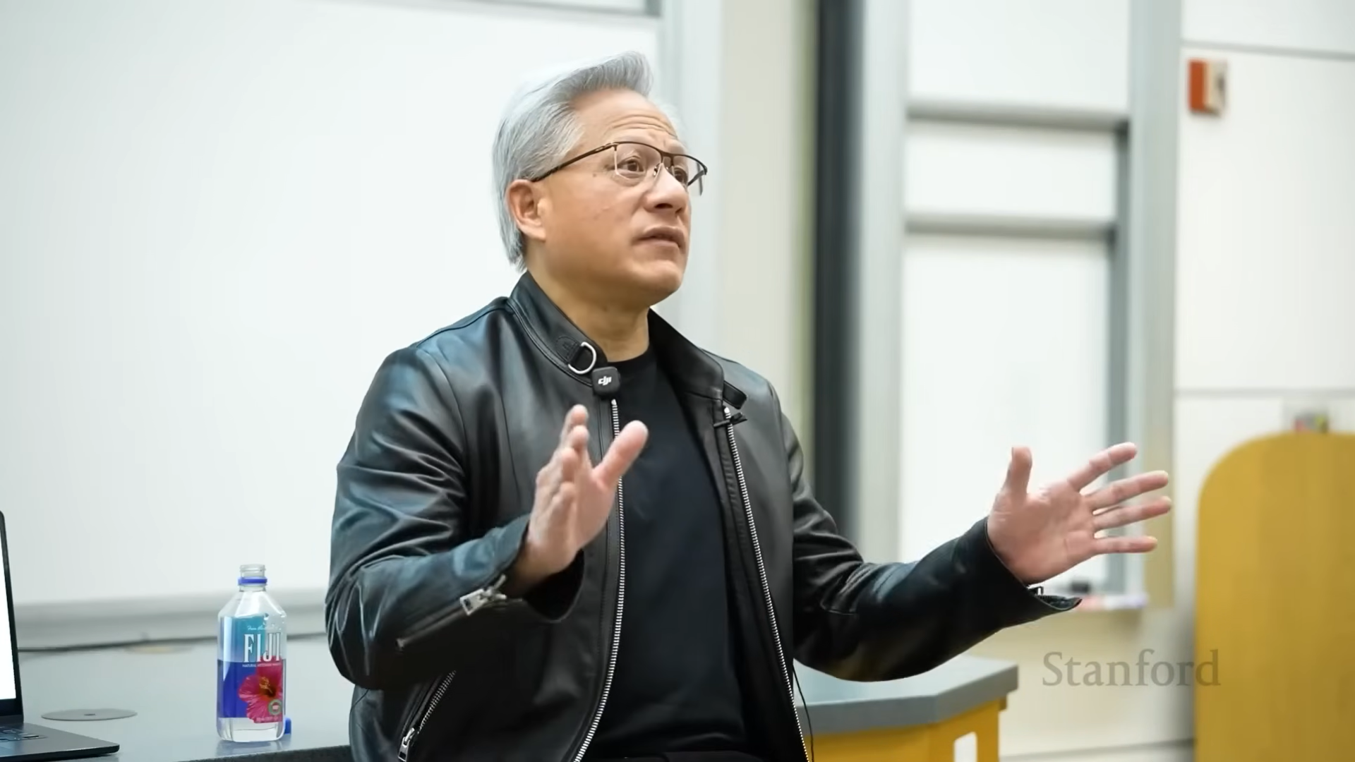 Nvidia CEO Jensen Huang speaking at a podium.