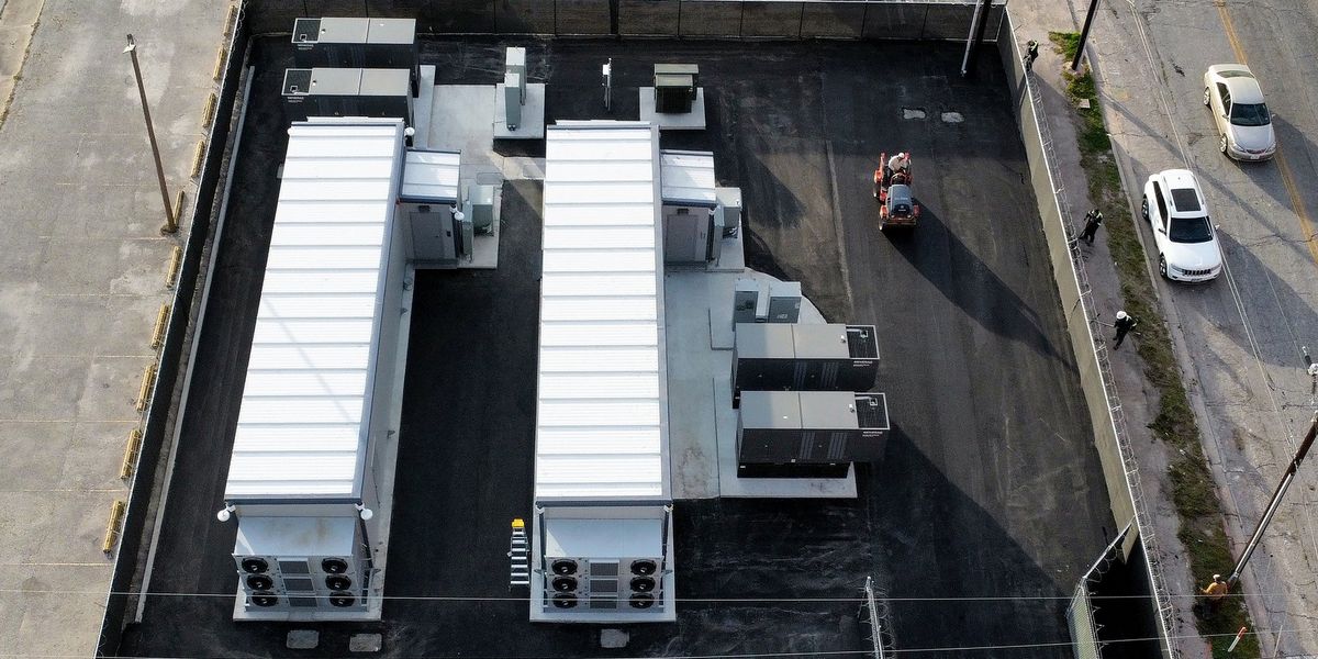 Truck transporting a large modular AI data center pod loaded with GPU racks
