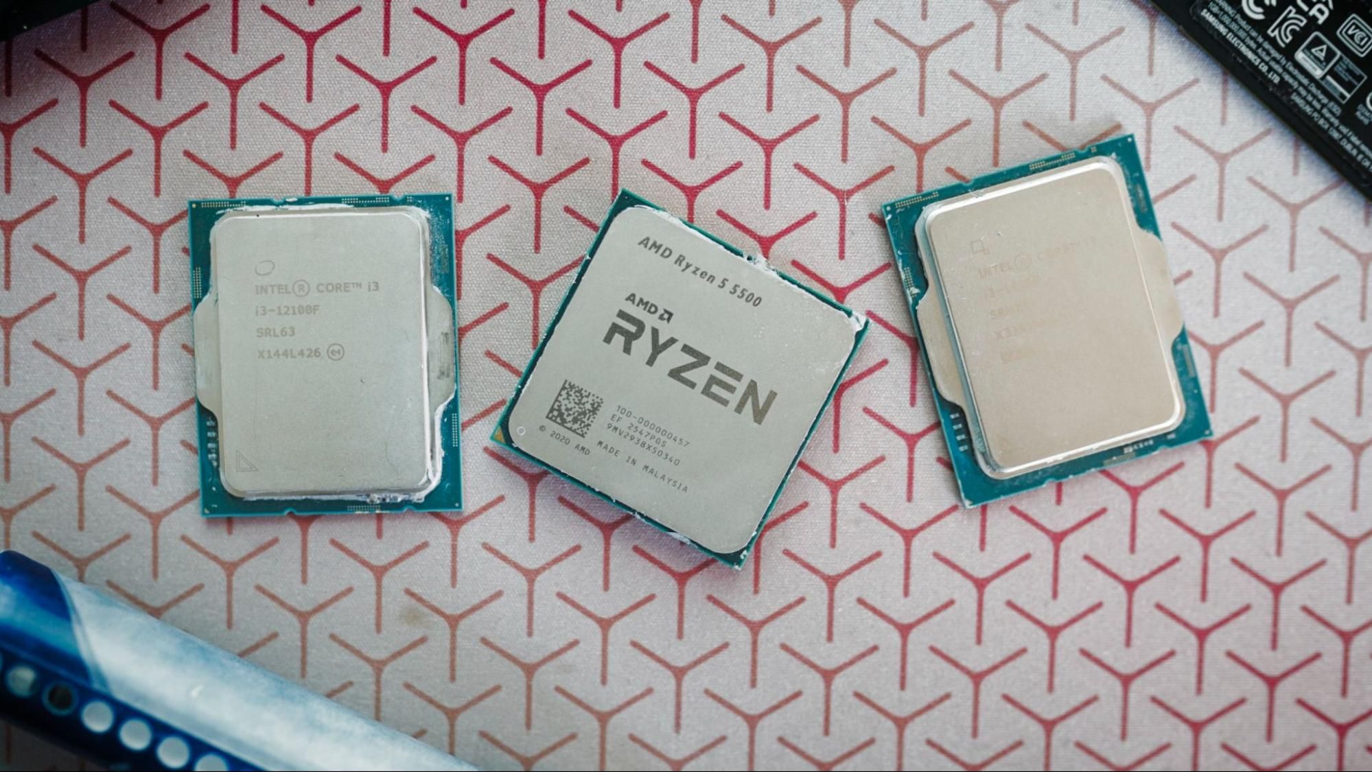 A close-up shot of three CPU processors arranged on a black surface, highlighting their complex pins and heat spreaders.