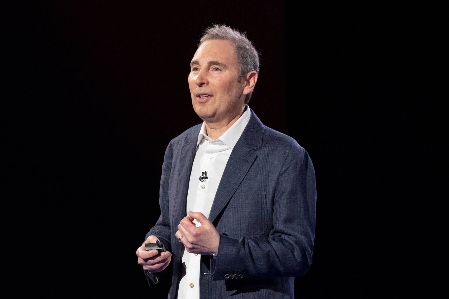 AWS CEO Andy Jassy at podium with graphics of Graviton and Trainium chips