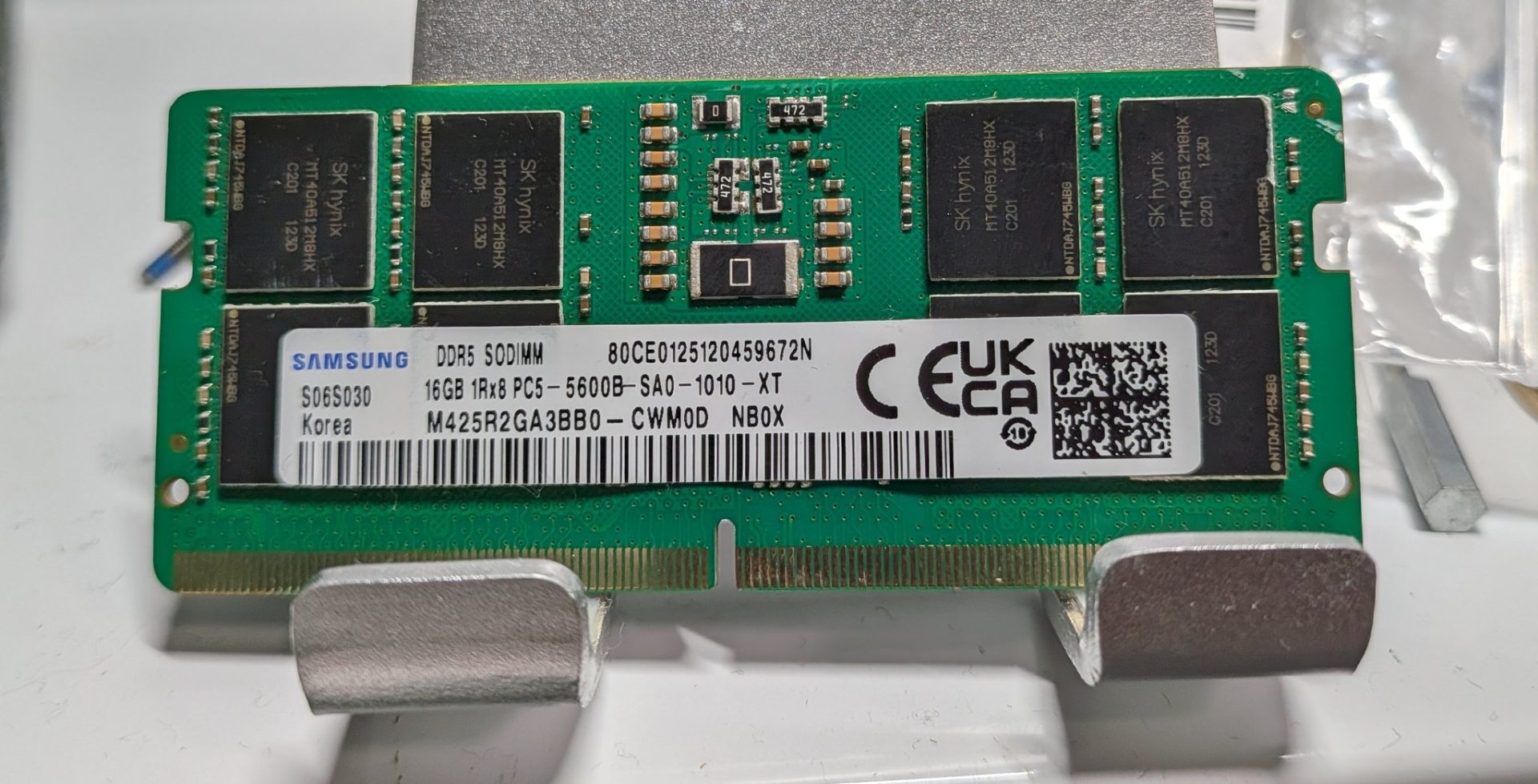 Close-up of a DDR5 RAM stick with a focus on the memory chips and labels, highlighting potential discrepancies.